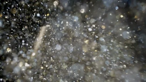 Gold and silver glitter flying after being exploded, bright sparkles bouncing Stock Footage 125617299