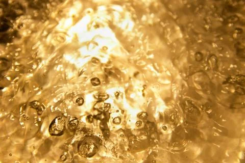 Gold background bubble texture. Close up beer or Oil. Element of design. Stock Photos