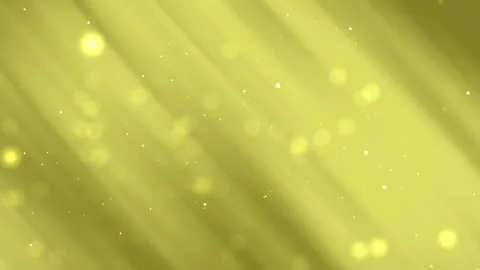 Gold background has blurry yellow lights and tiny white specks. Video stock 296167759