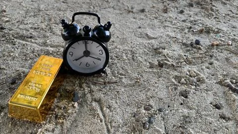 Gold bar and clock, suitable for  financial planning or investment Stock Photos