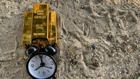 Gold bar and clock, suitable for  financial planning or investment, Stock Photos