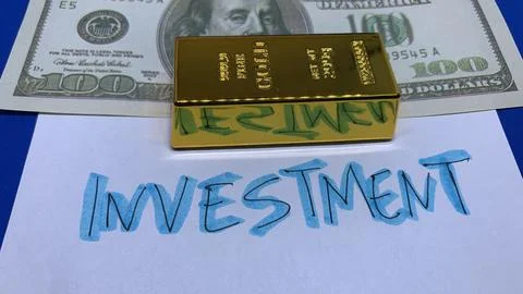 Gold bar placed in front of a US dollar banknote and investment concept Stock Photos