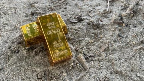 Gold bars and background sandy ground, perfect for  investment, Stock Photos