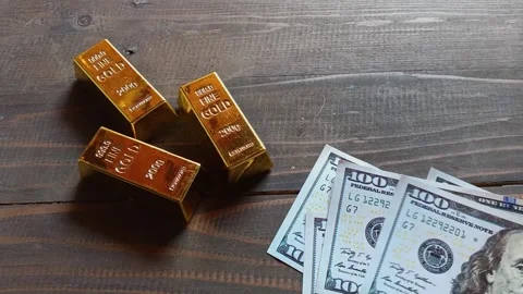 Gold bars and US dollar banknotes 動画素材 338077690