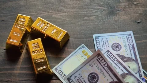 Gold bars and US dollar banknotes 動画素材 338205976