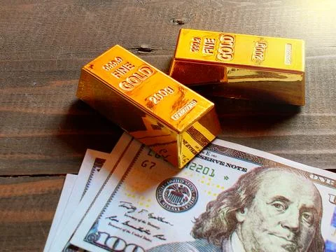 Gold bars and US dollar banknotes Stock Photos