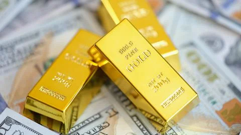 Gold bars on background of US dollars banknotes Stock Photos