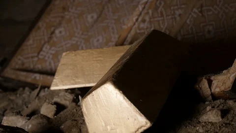 Gold Bars Being Picked Up By Gloved Hand Out Of Recently Excavated Stock Footage 128741879