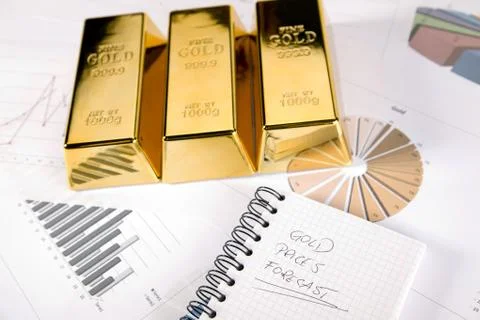 Gold bars on graphs and statistics Stock Photos