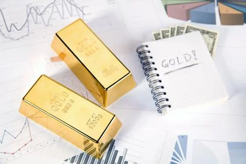 Gold bars on graphs and statistics Stock Photos