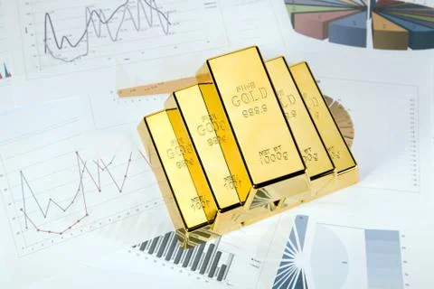 Gold bars on graphs and statistics Stock Photos