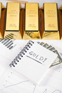 Gold bars on graphs and statistics Stock Photos