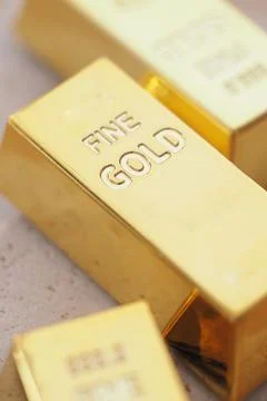 Gold bars placed on a table in a bright setting Stockfoto's