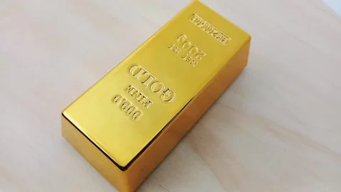 A Gold bars rotating on a wooden base Stock Footage 329081040