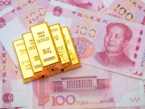 Gold bars stack on 100 Chinese yuan banknotes background, symbolizing China.. Stock Photos