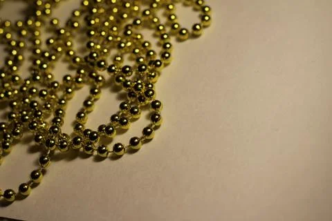 Gold beads on a light background Stock Photos