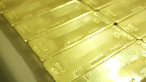 Gold biscuits arranged in rows on a table Stock Footage 77444030