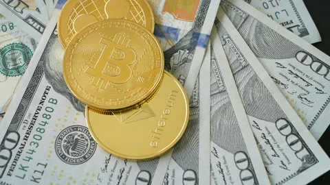 Gold Bit Coin BTC, ETC Cryptocurrency coins rotating on 100 dollars bills Stock Footage 88871355