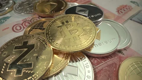 Gold Bit Coin BTC in the middle of table in surround of many other crypto coins Video stock 129614406