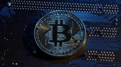 Gold Bitcoin BTC isolated on computer motherboard background, cryptocurrency Stock Photos