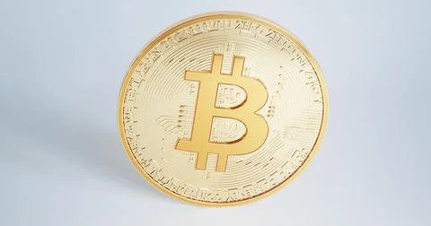 Gold bitcoin BTC rotating or rotates isolated on white background close-up. Illustrazione stock
