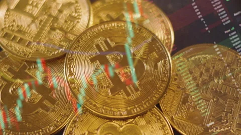 Gold bitcoin coins with reflection of cryptocurrency transaction graph Stock Footage 196910847