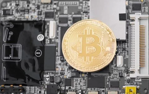 Gold bitcoin on a computer chip, macro shot. electronic money Stock Photos