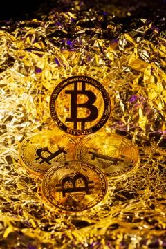 Gold Bitcoin Cryptocurrency in the centre surrounded by another coins with Stock Photos