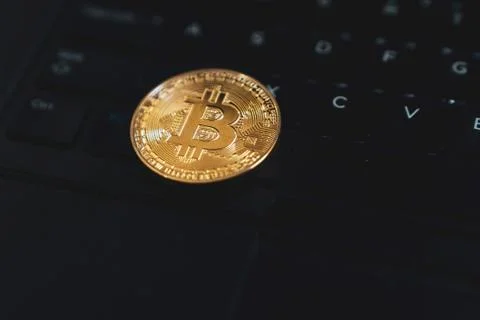 Gold Bitcoin Cryptocurrency Token on Computer Laptop Stock Photos