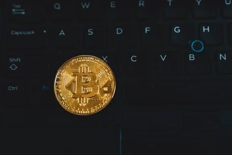 Gold Bitcoin Cryptocurrency Token on Computer Laptop Stock Photos