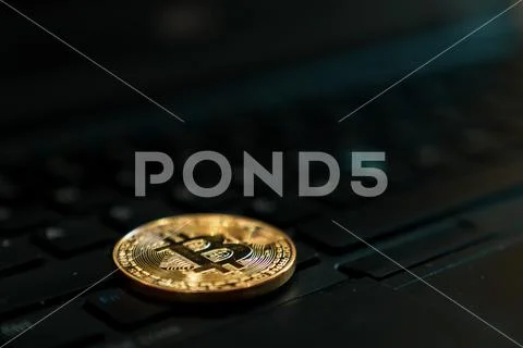 Gold Bitcoin Cryptocurrency Token on Computer Laptop Stock Photos