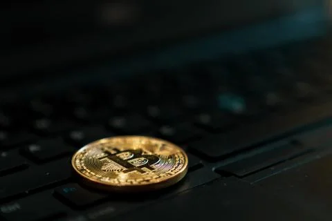 Gold Bitcoin Cryptocurrency Token on Computer Laptop Stock Photos