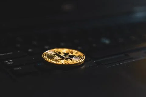 Gold Bitcoin Cryptocurrency Token on Computer Laptop Stock Photos