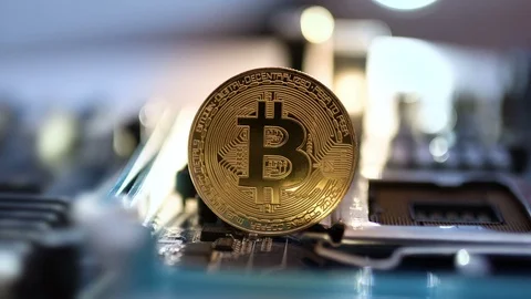 Gold Bitcoin With Motherboard Rotates On The Table Crypto Currency and Computer Stock Footage