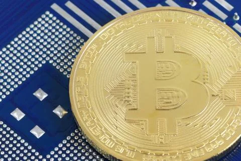 Gold bitcoin placed on a computer of hardware mainboard in concept of cryptoc Foto stock