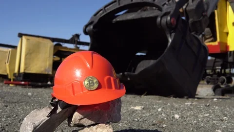 Gold bitcoin on a protective helmet next to the bucket of a mining excavator. Stock Footage 89307892