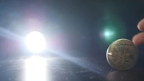 Gold Bitcoin rotates on a black background. light is shining on the background Stock Footage 85500621