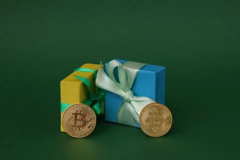 Gold Bitcoins with gift boxes. Stock Photos