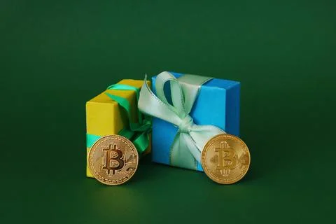Gold Bitcoins with gift boxes. Stock Photos