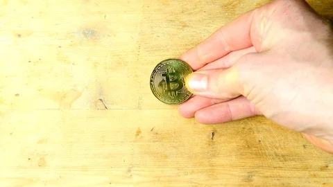 Gold BTC bitcoin crypto currency spun on table, spin spinning coin Stock Footage 85684587