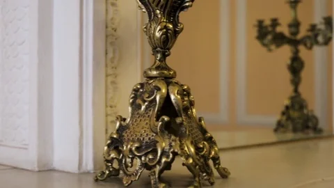 Gold candlestick close up. Gold Candlestick Old gorgeous wooden cupboard. Two Stock Footage 83186191