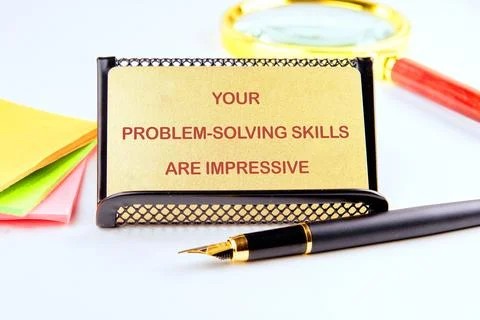 A gold card stating your problem-solving skills are impressive is placed on.. Stock Photos