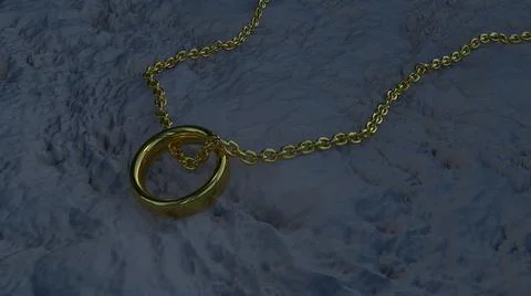 A gold chain with a ring on the dry gray ground at dusk. Jewelry.  Stock Illustration