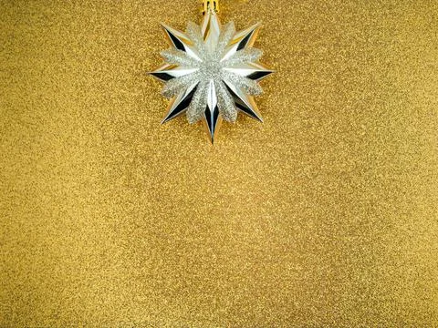 Gold Christmas tree toy with sharp tips,star,shiny golden background,copy space Stock Photos