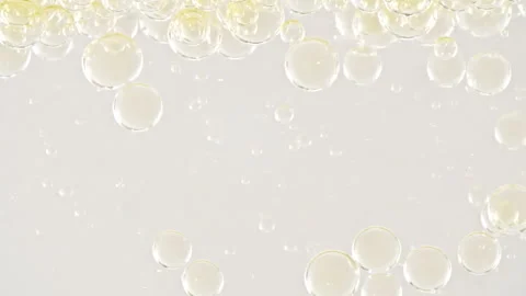 Gold Clear Bubbles Form and Float to Another Ones on Transparent Surface on Stock Footage 267963905