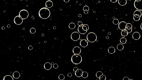 Gold Clear Bubbles Form and Float to Another Ones on Transparent Surface on Stock Footage 270924407