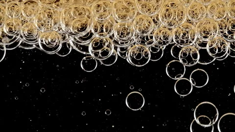 Gold Clear Bubbles Form and Float to Another Ones on Transparent Surface on Video stock 274149763
