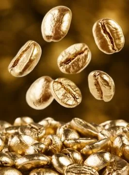 Gold coffee beans falling down Stock Photos