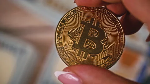 Gold Coin of Bitcoin on the Background of One Hundred Dollar Bills Stock Footage 211675796