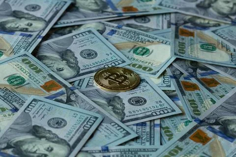 Gold coin of cryptocurrency Bitcoin in the rays of the sun on the background Stock Photos
